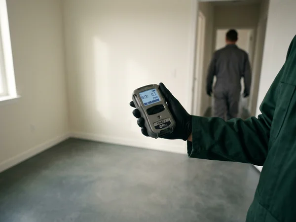 Air quality meter taking an ammonia reading in an empty room